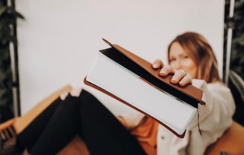 Lady handing you a Bible.
